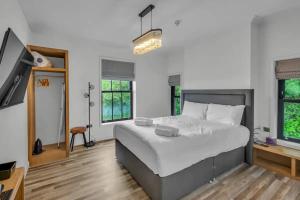 a bedroom with a large bed and a tv at Pass the Keys Larkey View a Tranquil Space for Two in Chartham