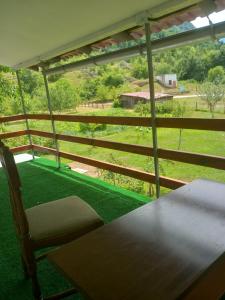 a room with a table and a chair and a view at Apartman Cicović in Foča +27 photos