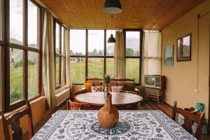 a living room with a table with a vase on it at Arte in Kazbegi in Kazbegi