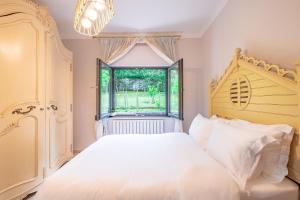 a bedroom with a white bed and a window at Villa 23 in Adalar +16 photos