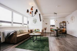 a living room with a couch and a table at Ferienwohnung Emma in Güntersberge