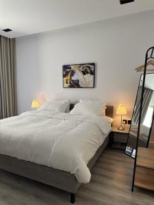 ein weißes Schlafzimmer mit einem großen Bett mit weißer Bettwäsche in der Unterkunft استديو شمال الرياض in Riad