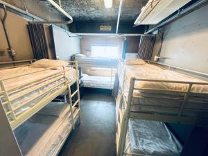 a room with three bunk beds and a window at G Guesthouse Itaewon In Seoul in Seoul +92 photos