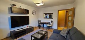 a living room with a couch and a flat screen tv at Apartament Gdynia Babie Doły in Gdynia