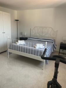 a bedroom with a bed with a blue and white comforter at DONNA MARIA ATTICO in Sapri