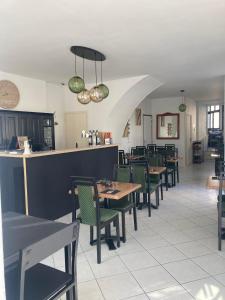 a restaurant with tables and chairs and a counter at Les chambres de l'Elysée in Pontrieux