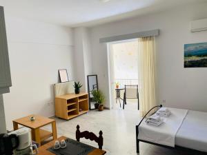 a living room with a bed and a table at Nearby Sea Studio in Rethymno