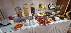 a buffet with fruits and vegetables on a table at Hotel Nefeli in Volos