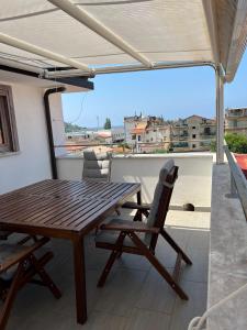 a wooden table and chairs on a balcony at DONNA MARIA ATTICO in Sapri
