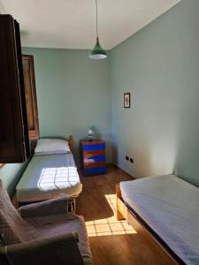 a bedroom with two beds and a blue wall at Le caselle in Nusco