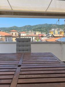 a chair on a balcony with a view of a city at DONNA MARIA ATTICO in Sapri +7 photos