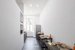 a kitchen with tables and chairs in a room at Trastevere Luxury Rooms in Rome