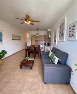 a living room with a blue couch and a table at Casa Bubal by Best Holidays Fuerteventura in Corralejo