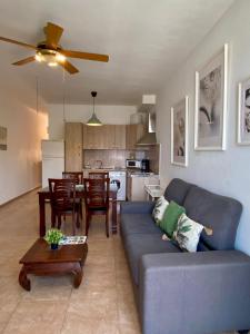 a living room with a blue couch and a kitchen at Casa Bubal by Best Holidays Fuerteventura in Corralejo