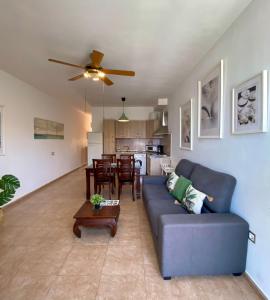 a living room with a blue couch and a table at Casa Bubal by Best Holidays Fuerteventura in Corralejo