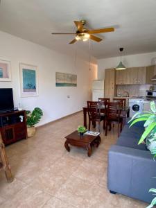 a living room with a blue couch and a table at Casa Bubal by Best Holidays Fuerteventura in Corralejo +42 photos