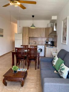 a living room with a couch and a table and a kitchen at Casa Bubal by Best Holidays Fuerteventura in Corralejo