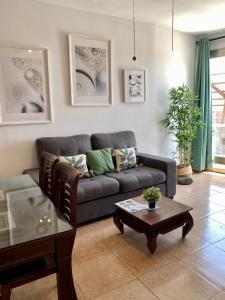 a living room with a couch and a table at Casa Bubal by Best Holidays Fuerteventura in Corralejo