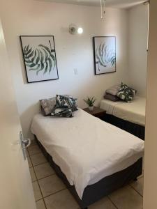two beds in a room with two posters on the wall at Peacehaven flat 208 in Scottburgh +9 photos