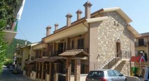 a building with a car parked in front of it at SIMPLY INN close to TIVOLI in Marcellina