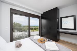 a bedroom with a bed with a large window at Villa Ira in Lachania +16 photos