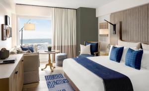 a hotel room with a bed and a view of the ocean at Newport Harbor Island Resort in Newport +129 photos