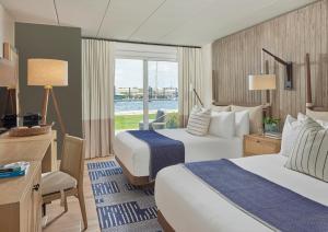 a hotel room with two beds and a window at Newport Harbor Island Resort in Newport