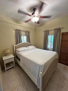 a bedroom with a bed with a ceiling fan at Casa Vista Mar, Los Patos, Paraiso, Barahona - 4x4 or All Terrain Recommended to Access Property in Los Patos