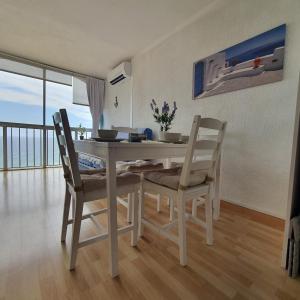 a dining room table and chairs with a view of the ocean at Bella Sylvia in Empuriabrava