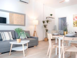 a living room with a couch and a table at ISG Apartments Triana Jacuzzi 1 in Seville