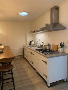 a kitchen with a stove and a counter top at appartement nearby Amsterdam in Naarden