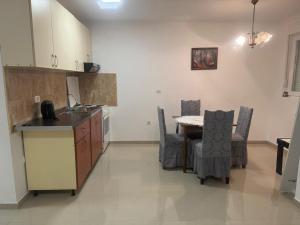 a kitchen with a table and chairs in a room at Tara Apartment in Herceg-Novi