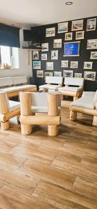 a room with tables and chairs and pictures on the wall at Atlantic Spot Guest House in Praia de Mira