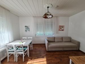 a living room with a couch and a table at Zöldház in Balatonmáriafürdő