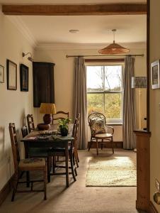a dining room with a table and chairs and a window at Garden View Apartment in Oswestry +14 photos
