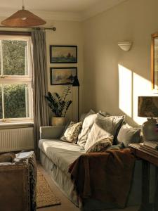 a living room with a couch and a window at Garden View Apartment in Oswestry +14 photos