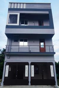 a blue and white building with black doors at Vijayaa Homes in Tiruvannāmalai +7 photos