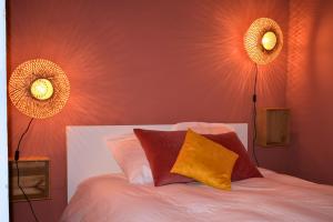 a bedroom with a bed with two lights on the wall at L'authentique - Centre - Calme - Équipé - Basque in Bayonne +10 photos