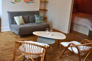 a living room with a couch and a table and chairs at L'authentique - Centre - Calme - Équipé - Basque in Bayonne