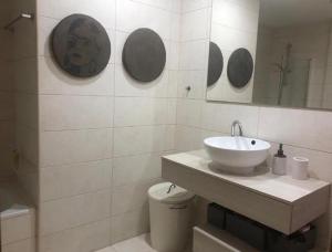 a bathroom with a sink and a mirror at Room Oportunity Guia Cascais in Cascais