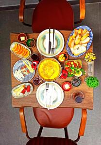 a wooden table with plates of food on it at Ottoman's Pearl Hotel in Istanbul