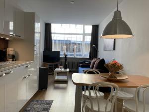 a kitchen and living room with a table and chairs at Marx Motel in Valkenburg