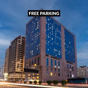 a large building with the words free parking on it at M Hotel Makkah by Millennium in Makkah