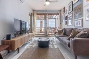 a living room with a couch and a flat screen tv at Casa Luna - Townhouse in Granada with open Terrace in Granada
