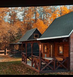 a log cabin with a black roof at Domek pod Śnieżką 2 in Miłków