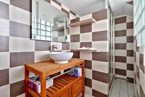 a bathroom with a sink and a mirror at Cosy Farm House in Wissous