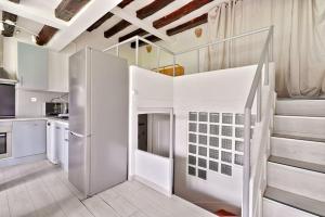 a white kitchen with a loft bed in a room at Cosy Farm House in Wissous +5 photos