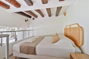 a bedroom with a bed with a wooden ceiling at Cosy Farm House in Wissous