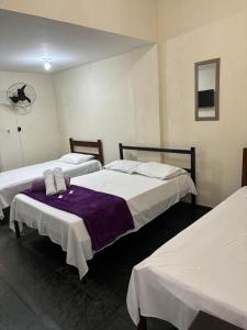 Postel nebo postele na pokoji v ubytování HOTEL DOCE LAR