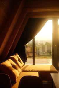 a bed in a room with a large window at Homoljski Vidikovac in Ždrelo